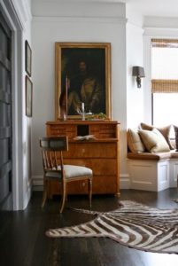 Living room in neutral color schemes accented by classic furnishings.