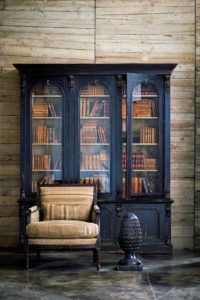 Ralph Lauren interior, painted and antiqued black book case, antique chair.