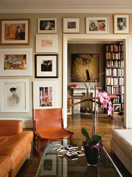 a living space with lots of pictures and a mix of modern and traditional elements