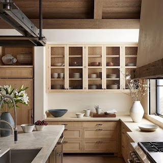 Kitchen with natural wood fronted refrigerator that matches the cabinets.
