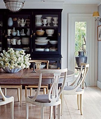 Dining room table, chairs and hutch filled with ceramic collections via Ruby Beets.