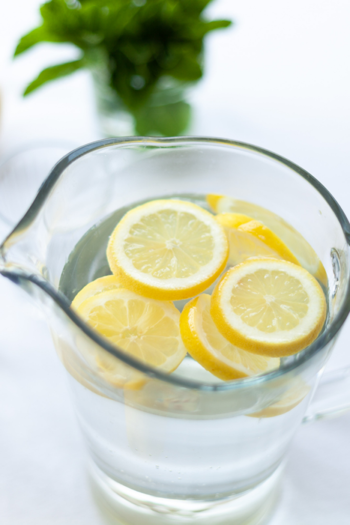 Lemon slices floating in a pitcher of water