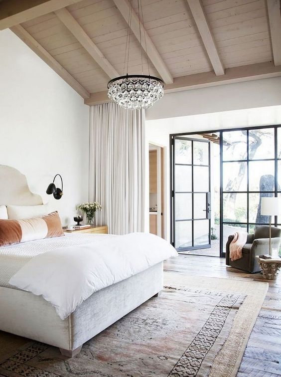 Open, airy bedroom retreat with French doors and natural materials