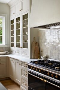warm neutral colored kitchen cabinets with rustic warm white backsplash tile and tower cabinets.